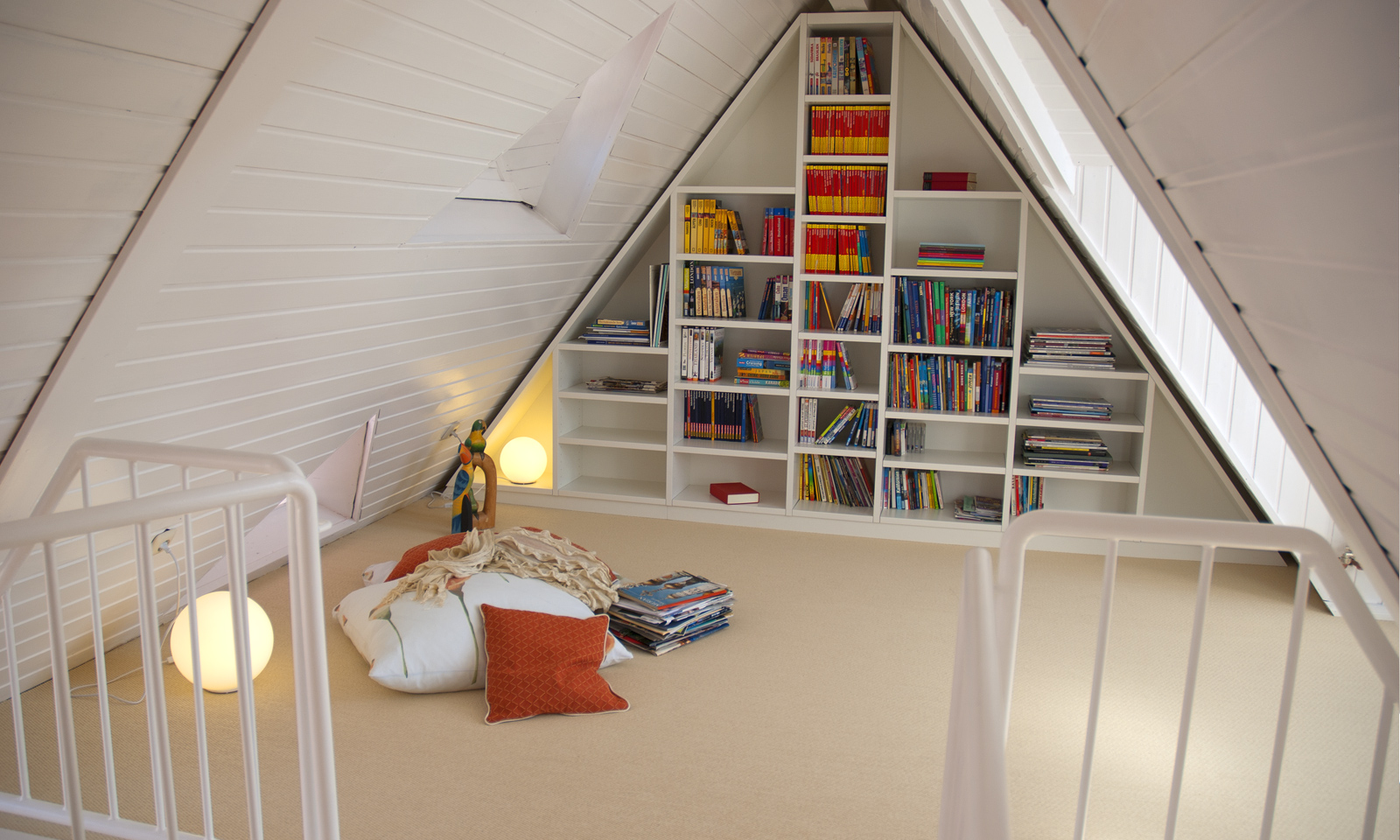 Loft conversion as a wonderful reading room with storage space for many books